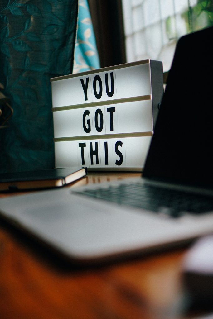 Motivational sign that says "you got this" next to a laptop.